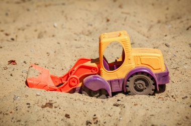 Oyuncak buldozer kum. Oyun küçük bir kazıcı