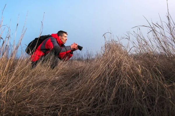 An experienced photographer takes pictures in nature. A professi