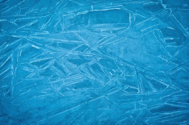 Background of blue cold winter ice. Texture of frozen surface. F