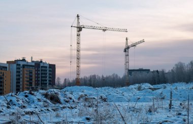 Winter season tower cranes on the construction of a buildings, i