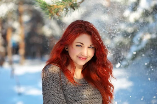 Beautiful charming girl with red hair in the winter park. Pensiv — Stok fotoğraf