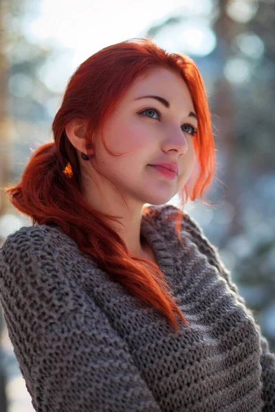 Beautiful charming girl with red hair in the winter park. Pensiv — Stok fotoğraf