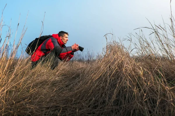 Un fotógrafo experimentado toma fotos en la naturaleza. Un profesor. —  Fotos de Stock