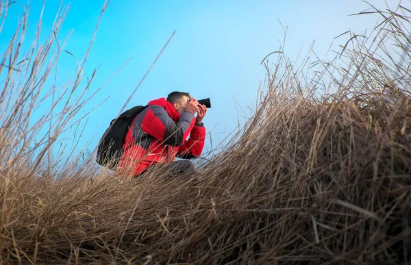 An experienced photographer takes pictures in nature. A professi