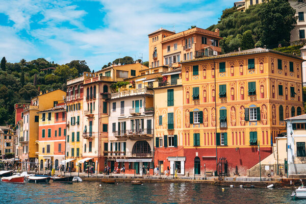 Scenic view of Portofino, one of the most popular coastal villages on the Italian Riviera. Mediterranean landscape of yacht-filled harbor and colorful buildings in the background. June, 2018 - ITALY