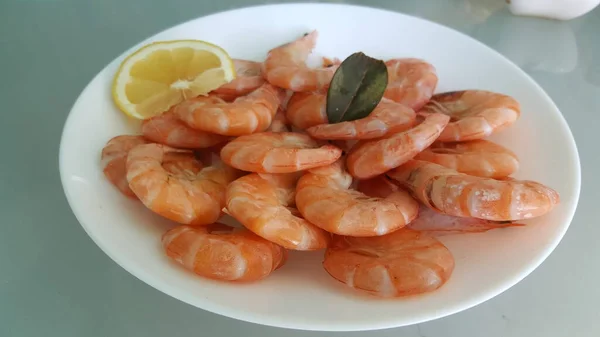 Kitchen and food, cooked shrimp, shrimp in a plate. Boiled shrimp with lemon. roasted prawns on white plate,