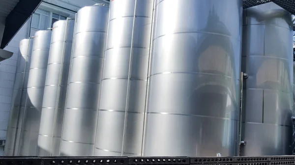 Stainless steel tanks in a modern winery. modern winery. Steel tanks pressurized fermentation tanks used for making wine. Steel tanks are used for the production of sparkling wine