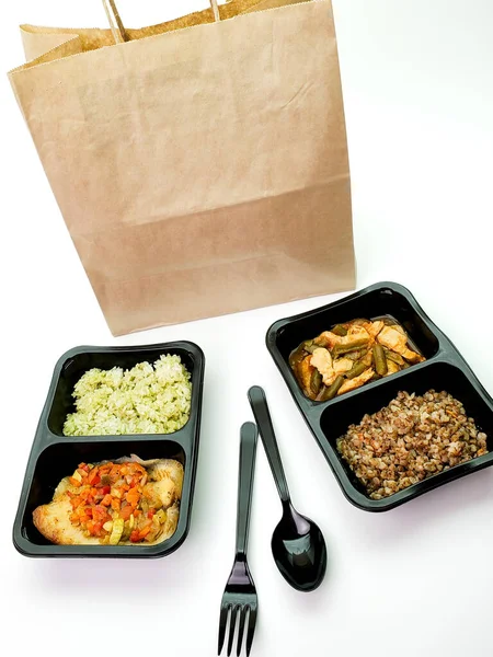 Various types of ready meals in disposable containers on the table