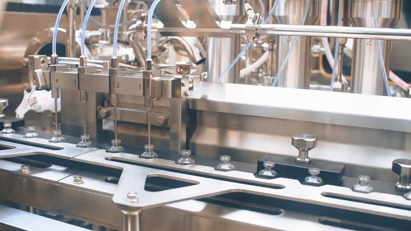 Medical vials on an automatic production line for filling vaccines and injections. coronavirus