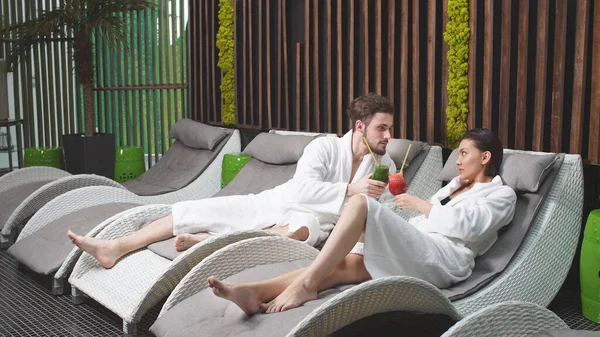 Beautiful man and a beautiful woman are relaxing in the Spa drinking non -alcoholic cocktails