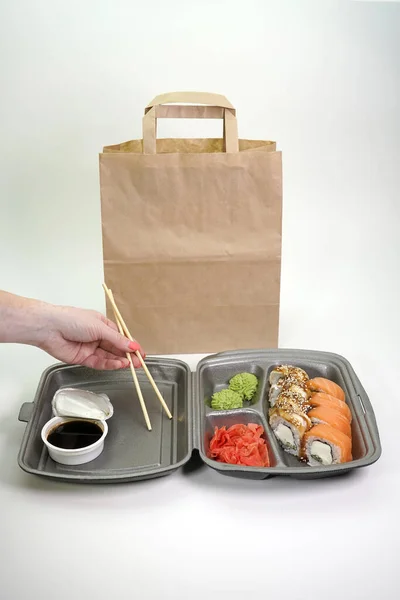 online food ordering and home delivery Service during the coronavirus quarantine. Delivery of sushi and rolls