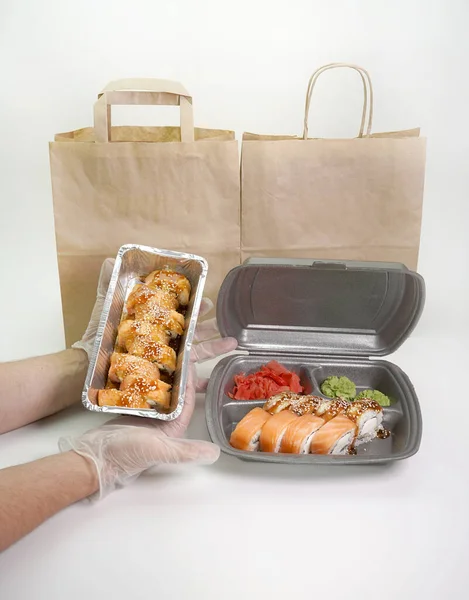 food Supplies. Sushi and rolls with salmon and shrimp. The concept of food delivery on self-isolation