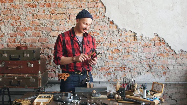 master jeweler works at his workplace in a jewelry workshop. Jewelry making, handmade