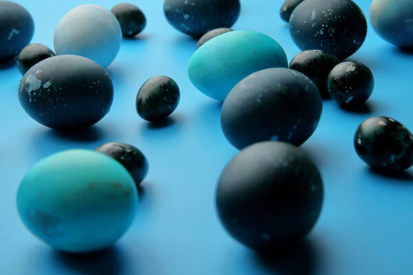 Easter chicken and quail eggs on a pastel blue background. The view from the top. Easter concept.