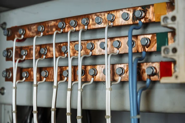 Electric copper bus with ground connection. Cables connected to an electric ground bus