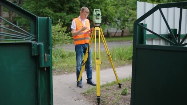Маркшейдер на работе, измеряющий расстояние — стоковое видео