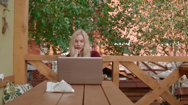 Молодая женщина говорит по скайпу с помощью ноутбука — стоковое видео