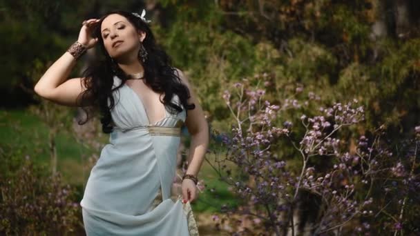 Young woman in white dress in spring park — Stock Video