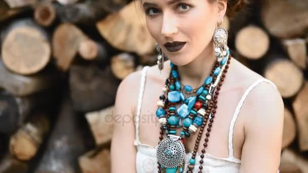 Young caucasian woman pose with stack of wood — Stock Video