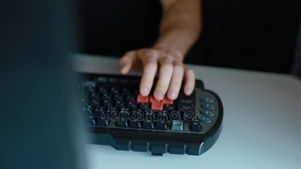 Человек играет в видеоигры с помощью клавиатуры — стоковое видео