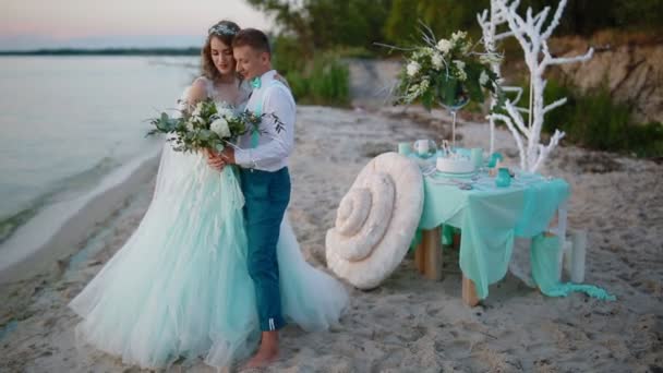 Bruden och brudgummen posing nära havet — Stockvideo