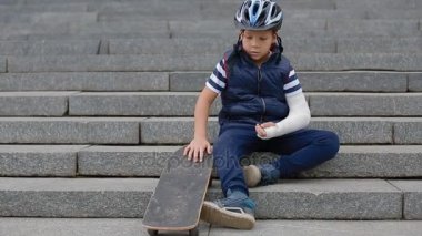 Kırık kol ile sıkılmış beyaz çocuk