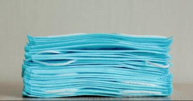 Disappearing stack of medical masks. Stop motion.