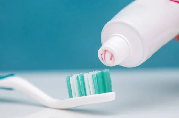 dental care, oral care products close-up on a light green background