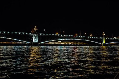Gece cityscape nehir ve Saint-Petersburg Bridge'de .