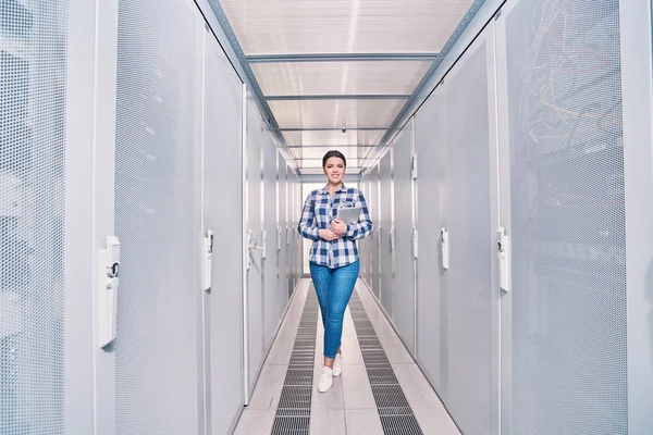 female technician working on server maintenance in white server room