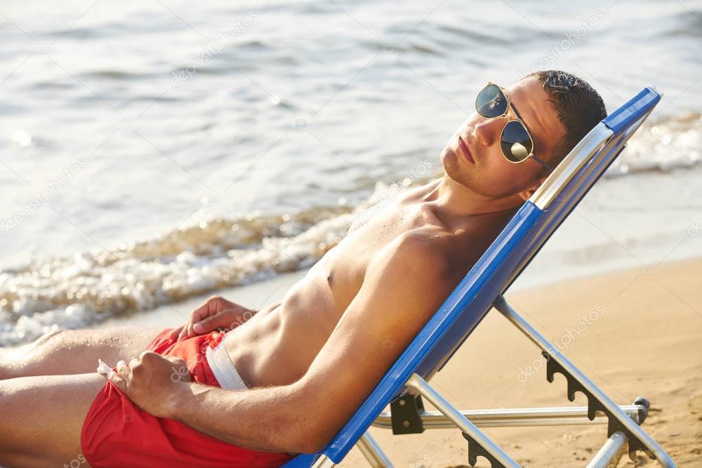  Beautiful Fitness Model Relaxing, Sunbathing Lying On Sand. Summertime Travel Vacation