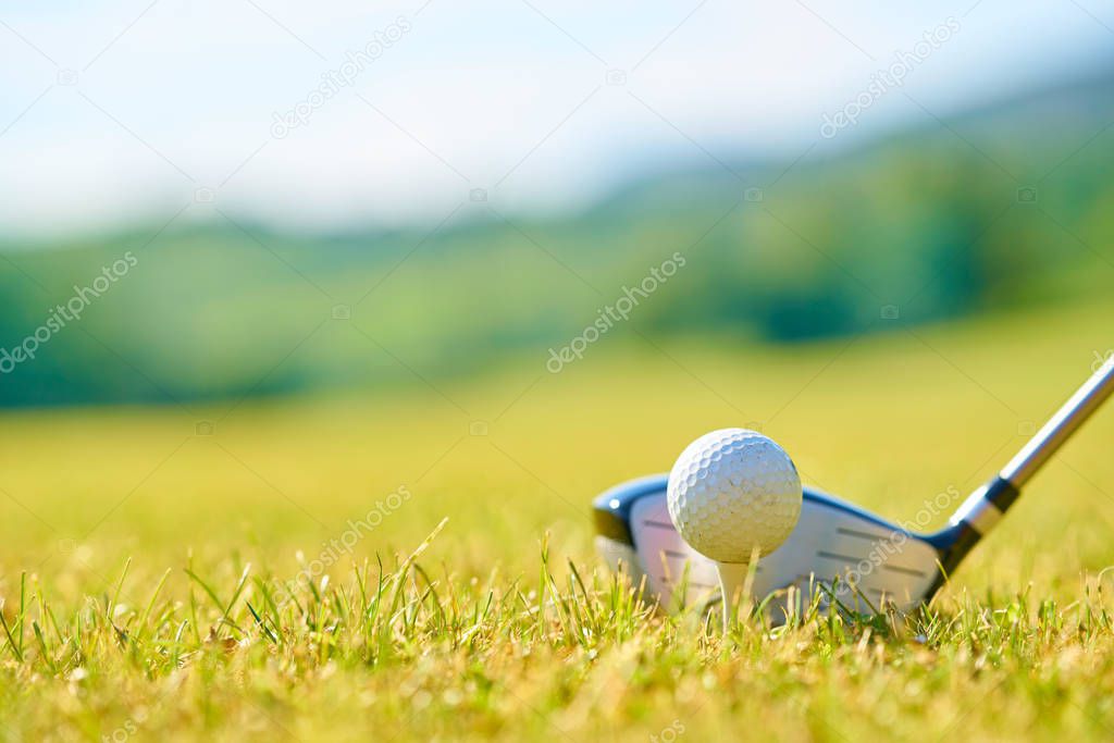Golfing ball on a green grass.