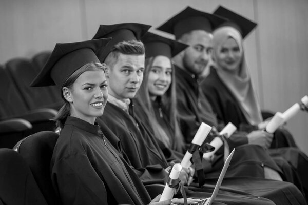 Group of Diverse International Graduating Students Celebrating, sitting and standing, concept