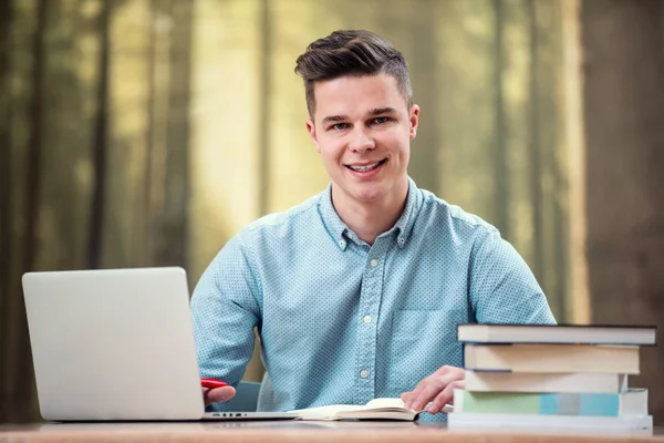 Young Attractive Man Using His Phone Laptop Sourounded Books — Stock Photo, Image