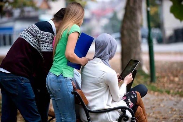Group Young People Using Laptop Tablet Park Bench Having Fun — Stock Photo, Image