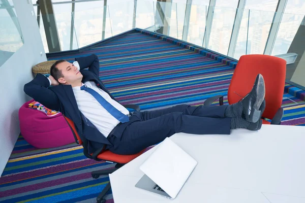 Young business man sleeping on the office desk