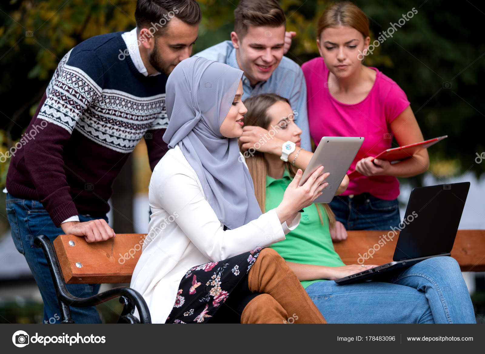 Group Young People Using Laptop Tablet Park Bench Having Fun