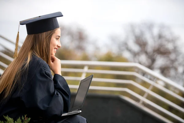 Pretty young  graduate girl with laptop