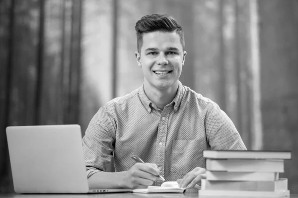 Young Attractive Man Using His Phone Laptop Sourounded Books — Stock Photo, Image