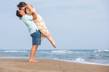 Kumsalda yürüyen çift.