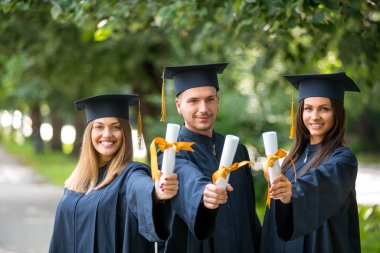 Eğitim, mezuniyet, insanlar kavramı - harç panoları ve bekarlığa veda önlük diploma ile mutlu uluslararası öğrenci grubu
