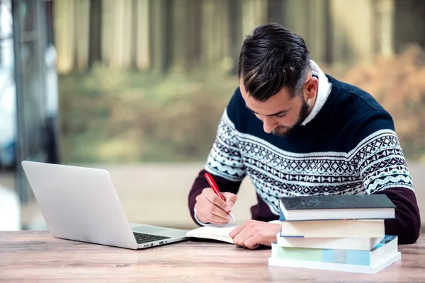 Young Attractive Man Using His Phone Laptop Sourounded Books — Stock Photo, Image