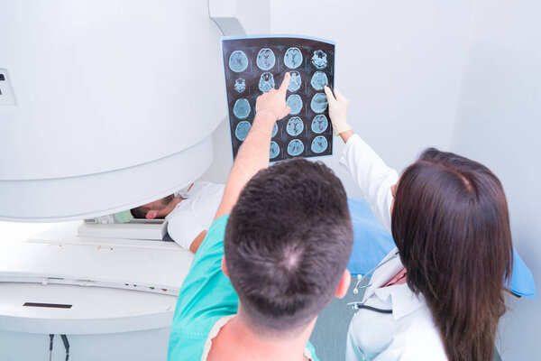 Confident pleasant doctor working with MRI scan results