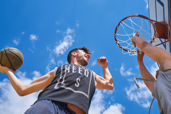 Basketball player in action flying high and scoring