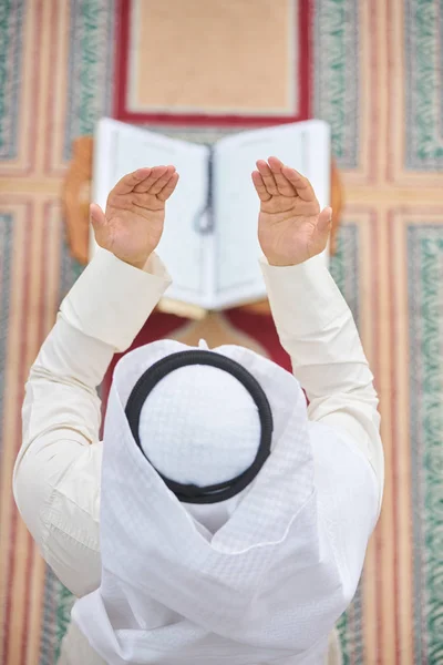 Religious muslim man praying inside the mosque