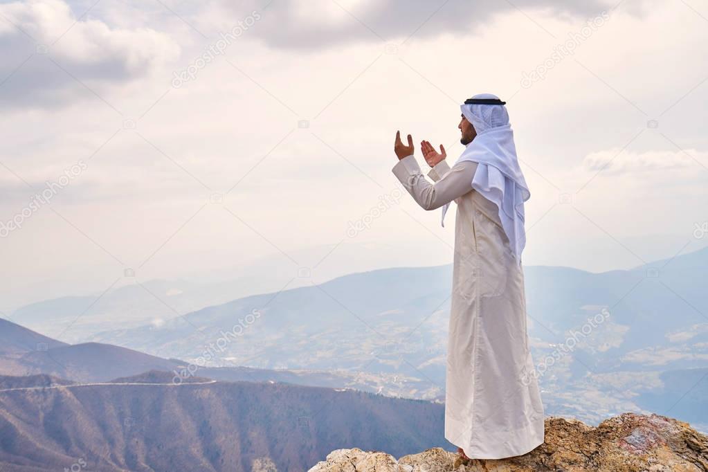 The iIslamic man praying   on the mountain.