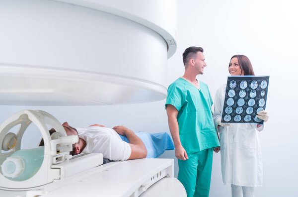 Confident pleasant doctor working with MRI scan results