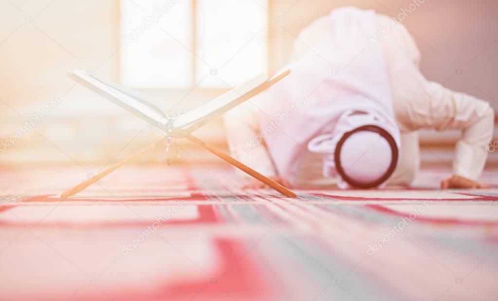 Religious muslim man praying inside the mosque