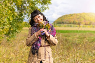 A woman walks in nature outside the city in the Park.