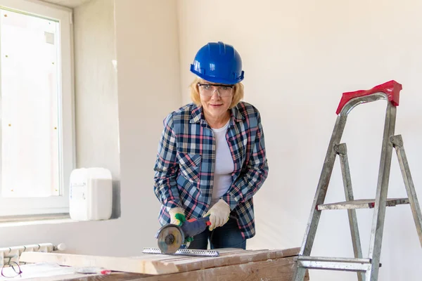 Bauarbeiterin im Zimmer des Hauses bei Reparaturen. — Stockfoto